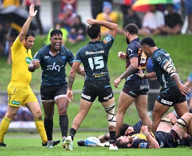 William Havili (centre) celebrates scoring a try for Moana Pasifika at Teufaiva Sport Stadium....