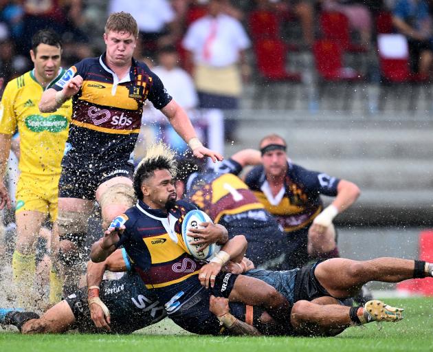 Highlander Folau Fakatava gets taken down in a tackle. Photo: Getty Images 