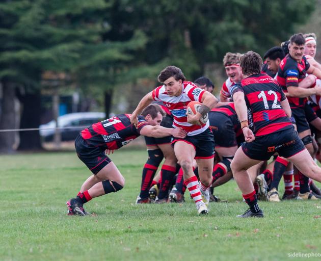 Burnside halfback and co-captain Joel Lam tries to break a tackle during his side’s 45-7 win over...