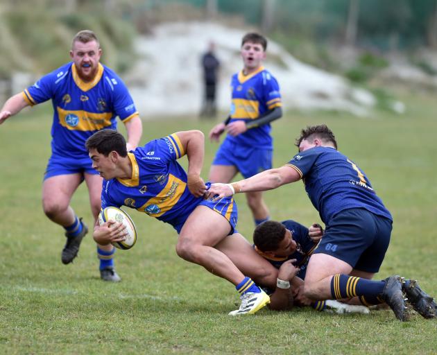 Hame Toma (centre )and Hunter Fahey (right) for Dunedin try to slow down Josh Whaanga (left) for...