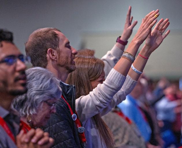 People raise their hands during the Southern Baptist Convention in Indianapolis. PHOTO: REUTERS