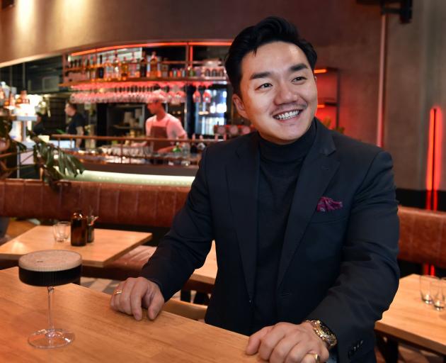 Graze and Glow owner Andre Shi awaits customers on the opening night of his new restaurant, in...