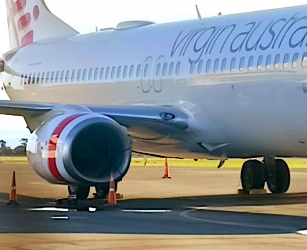 A Virgin Australia aircraft sits at Invercargill Airport after being forced to do an emergency...