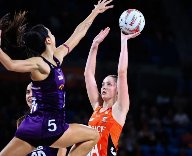 Giants goal attack Sophie Dwyer lines up a super shot under the pressure 
...