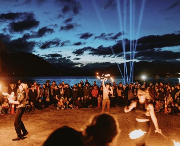 People dance on the lakefront during Wanaka’s Matariki celebrations in 2023. PHOTO: KAHU YOUTH