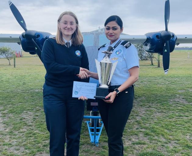 New Zealand Airline Academy trainee pilot Sneha Baskaran (right) is presented with the Morane...