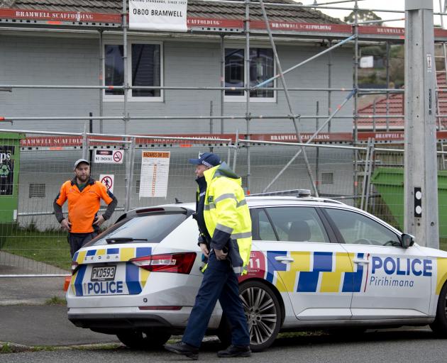Police talk to a contractor outside a property in Corstorphine Rd this morning after an...