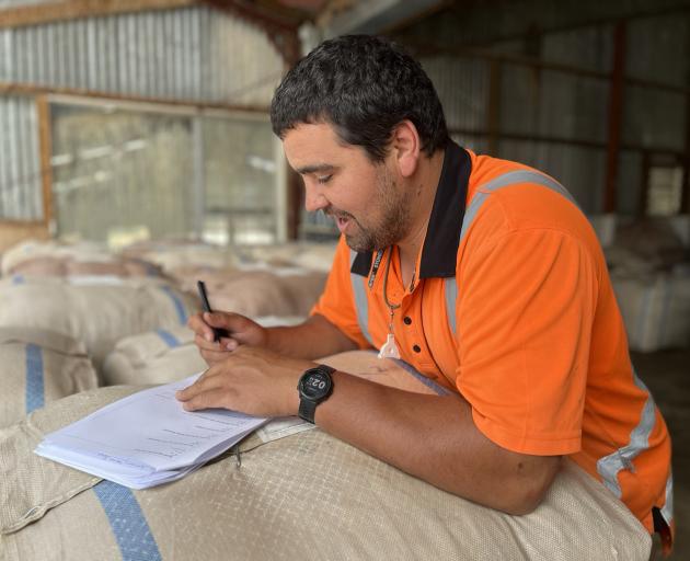 Pāmu Mt Hamilton Station farm manager Thomas Scanlan fills in a questionnaire about his working...