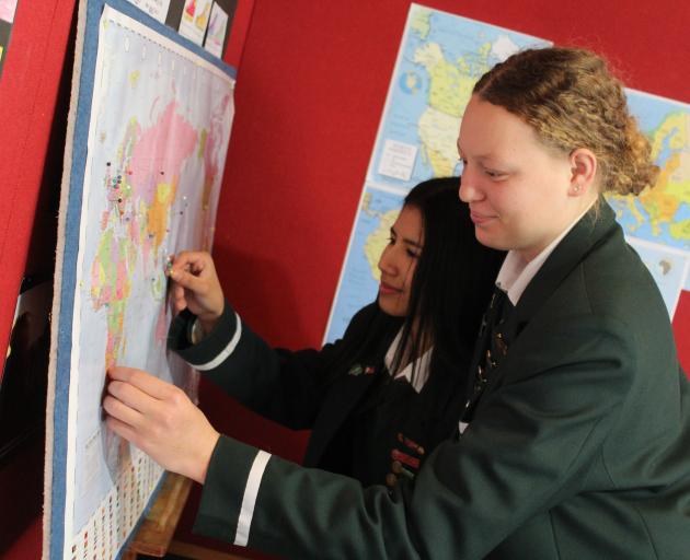 Waimate High School pupils Jashlie Gascon, 17 (left), and Nadia Ferreira, 17, place a pin on the...