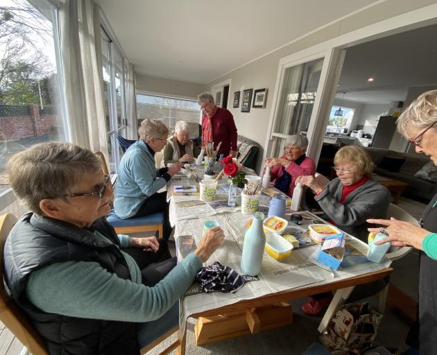 Willowbridge Women’s Institute members learn how to decorate bottles using découpage.