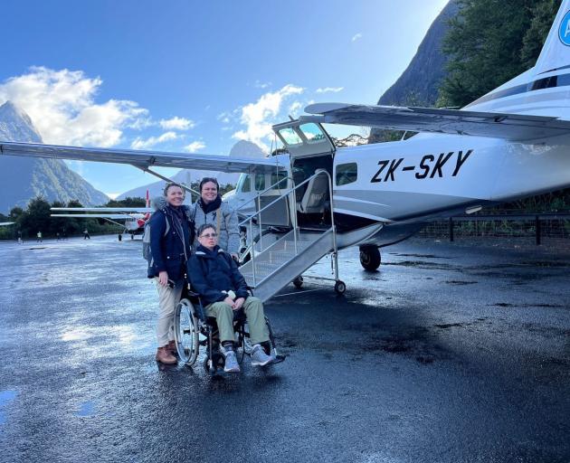 Shauna Mayes Foster, centre, was the first person to use Air Milford’s new accessible stairs —...