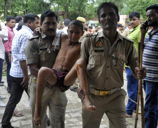 A boy, who was injured in a crowd crush at a religious gathering, is taken to a hospital for a...