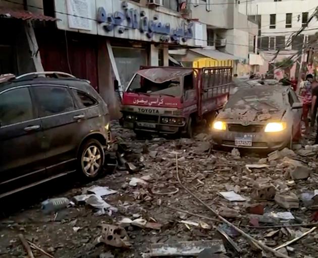 Damaged cars and buildings in Beirut following an Israeli drone strike. Photo: Reuters 