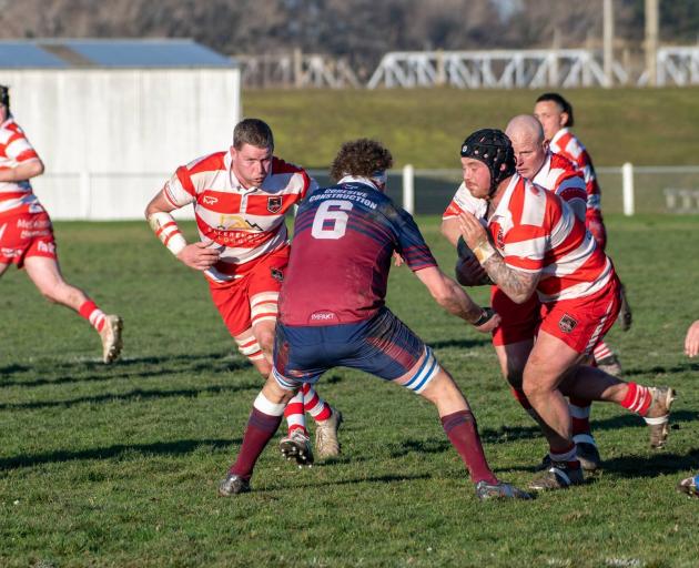 Clutha hooker Josh Turnbull runs into contact against West Taieri captain Conor Beaton during...