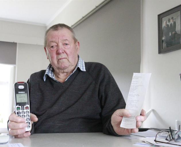 Brian Cherry with his phone and some of the Paysafecard vouchers the scammer told him to buy....