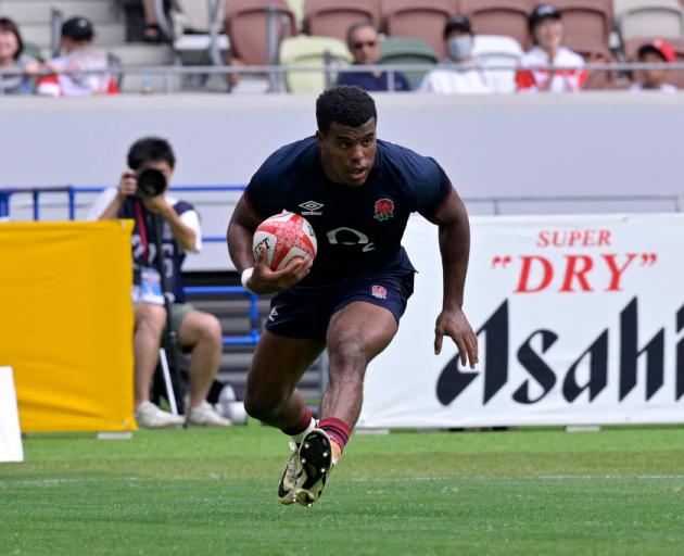 England winger Immanuel Feyi-Waboso runs in to score his team's third try against Japan at...