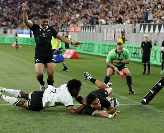 Billy Proctor of the All Blacks scores a try with teammate Caleb Clarke against Fiji during the...