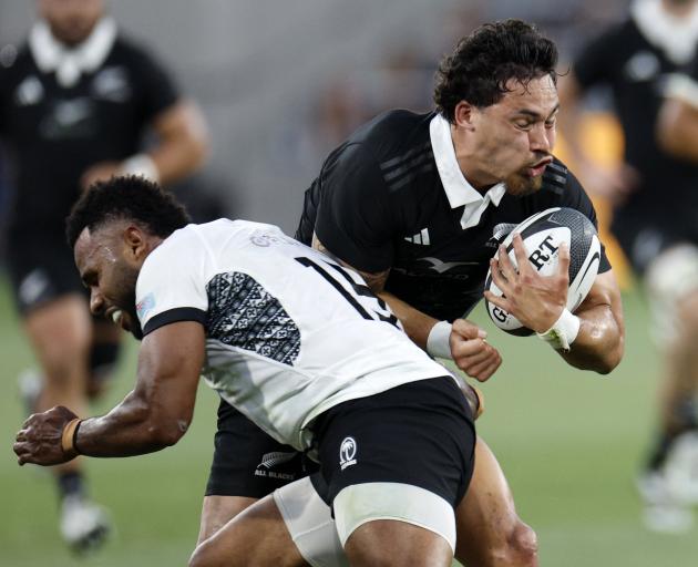 All Black Billy Proctor collides with Fiji’s Vilimoni Botitu during the one-off test at...