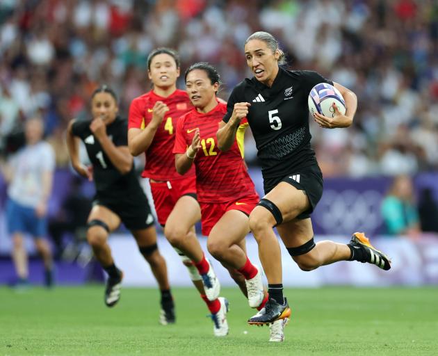 Sarah Hirini breaks away to score New Zealand's first try during their quarterfinal against China...