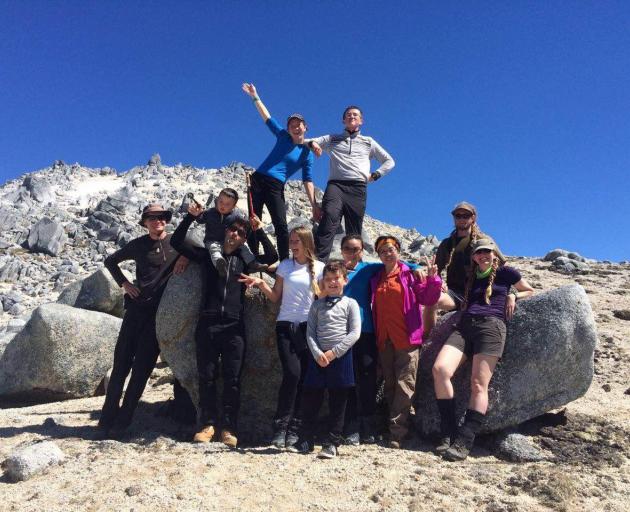 Lulu Sun (top left) on Mt Titiroa in Fiordland, with family and friends, and bush guide and Otago...