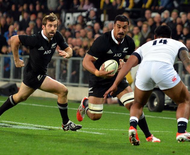 All Blacks flanker Jerome Kaino, with Conrad Smith in support, charge towards England’s Manu...