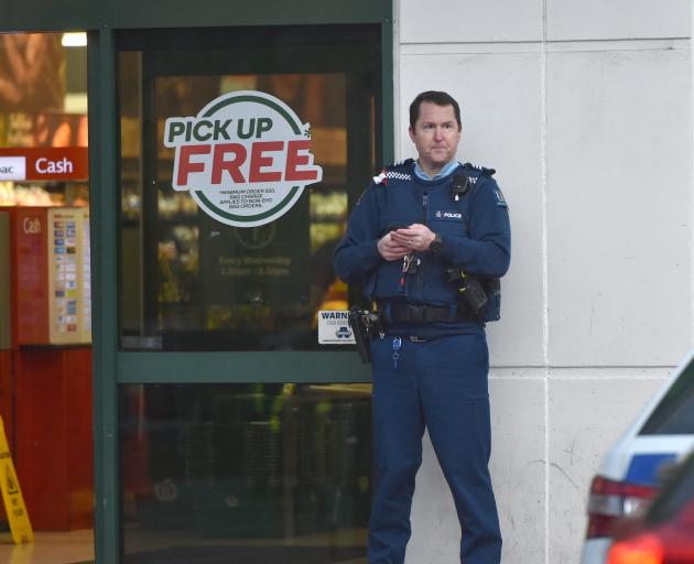 An armed officer outside Countdown in central Dunedin. Photo: Gregor Richardson