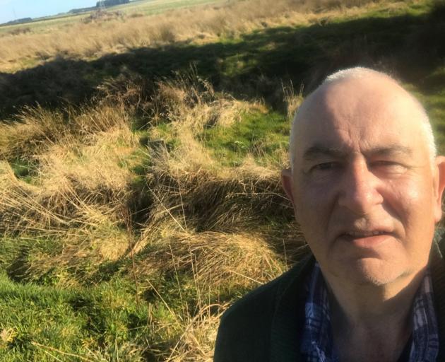 Gore Waimumu Catchment Group chairman Murray Wards inspects the Wards Wetland construction site...