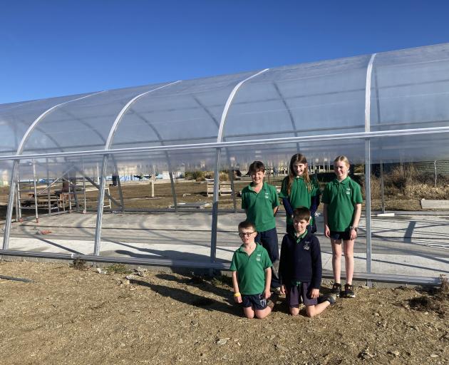 Posing outside a tunnel house being built at their school are Poolburn School pupils (clockwise...