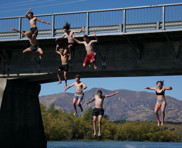 A group of Mount Aspiring College students jump off the Albert Town Bridge in defiance of the...