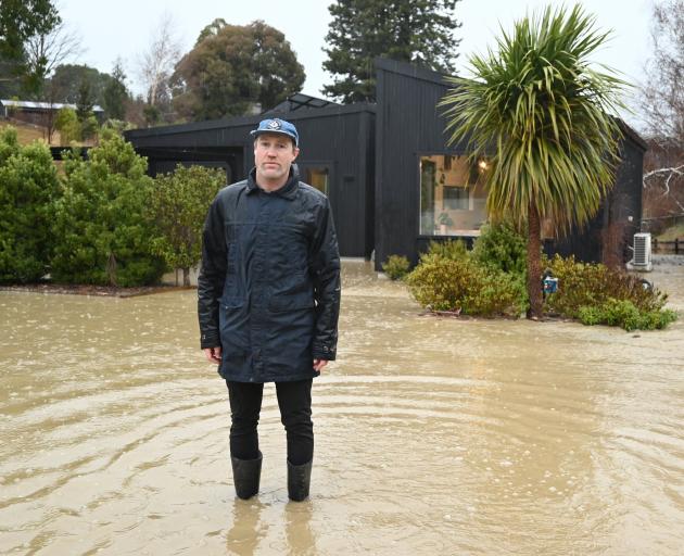 Wānaka homeowner Sam Smoothy stands in front of his Wineberry Lane property, where rushing silt...