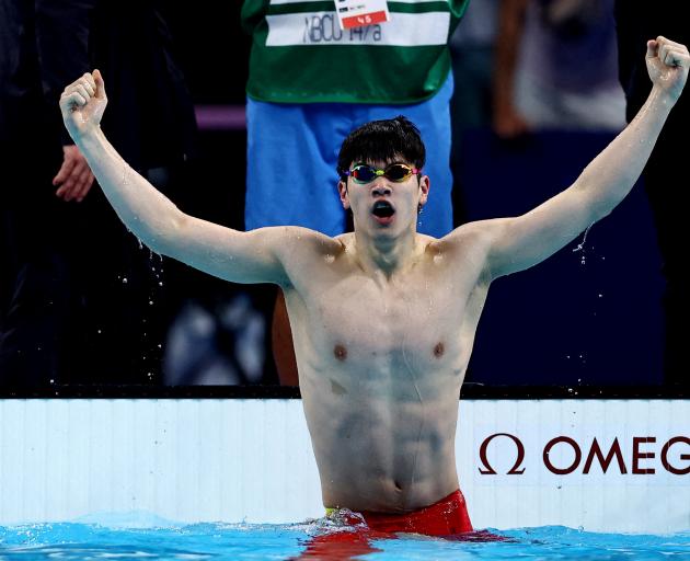 Zhanle Pan of China reacts after winning the race in a world record time. Photo: Reuters