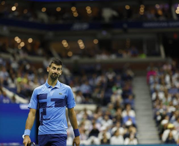 Novak Djokovic looks at a replay between points against Alexei Popyrin (not pictured) in a men's...