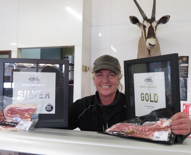 The Fridge Butchery owner and operator Jayne McMillan shows off the new awards the business...