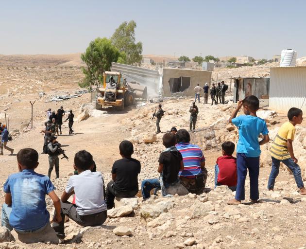 Palestinians are forced to watch their homes being destroyed by Israeli soldiers. PHOTOS: COLE...