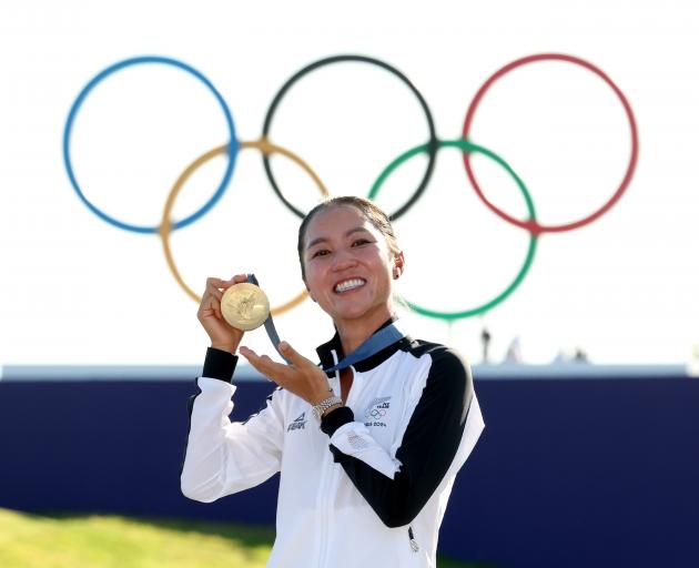 Lydia Ko shows off the gold medal she won in the women’s individual stroke play golf tournament...