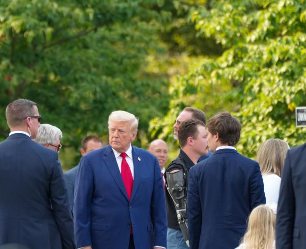 Donald Trump attends a wreath laying ceremony at Arlington national cemetery on Monday. Photo:...