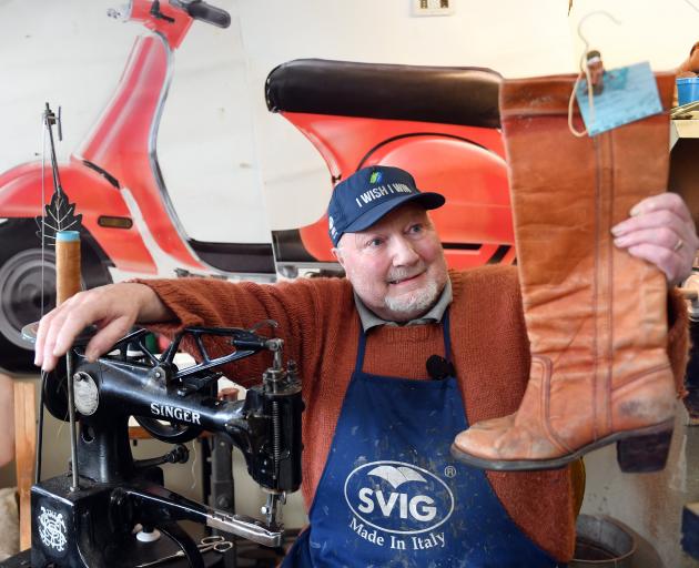 Mornington shoe repair shop Country Cobbler owner Greg Fox holding the shoes of an old customer,...