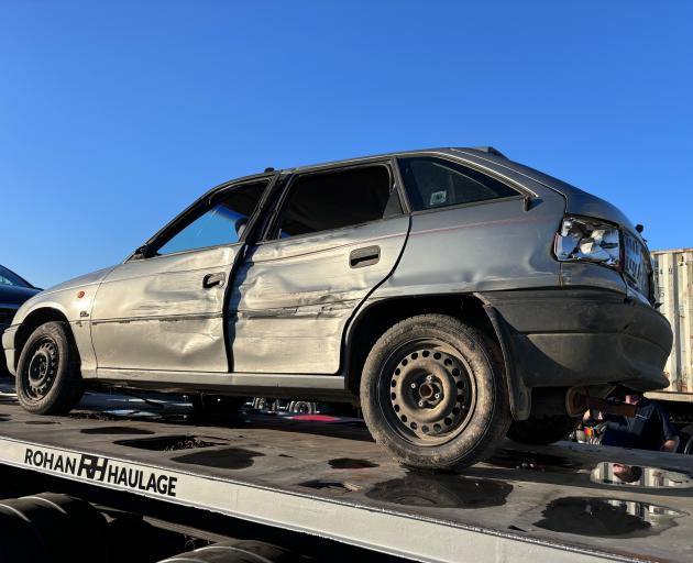 Dunedin resident Isaac Tripp’s stolen grey Holden Astra sits on the back of a Rohan Haulage truck...