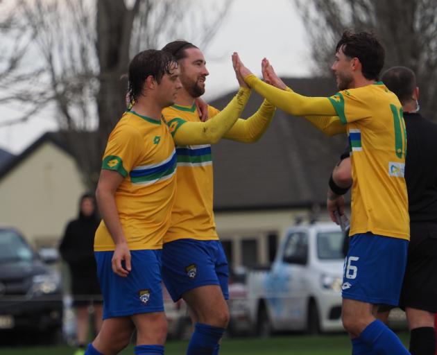 Cashmere Technical’s Garbhan Coughlan (centre) celebrates one of his five goals against Nomads....