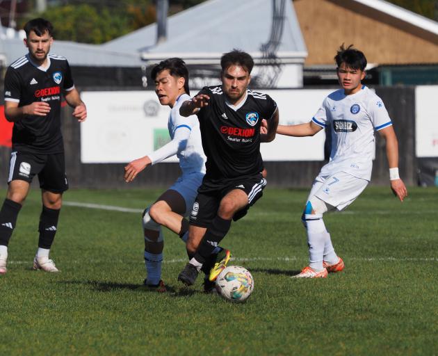 Coastal Spirit’s Matt Bergin beats a pair of Christchurch United defenders during his team’s 1-0...