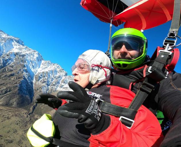 Betty Phillips enjoying her first tandem parachute jump with her NZONE Skydive instructor Boris,...