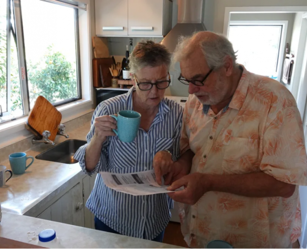 Kerikeri retirees John Logie and Lyn Bellinger, of Kerikeri, study their latest power bill. Photo...