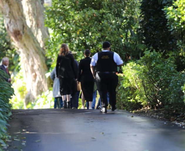 The jury entering the property from a side entrance. Photo: RNZ