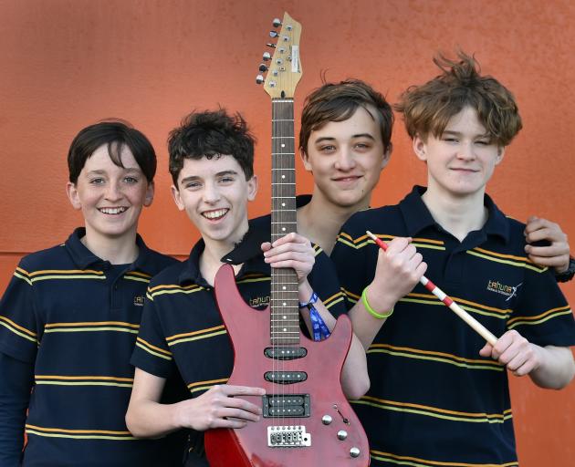 The Eight Balls band members (from left) bassist Daniel Cameron, 12, lead singer Alex Smith, 13,...