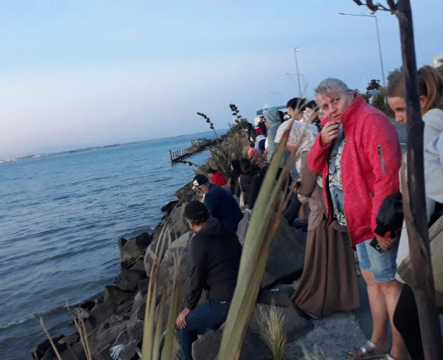 Busy nights on Marine Parade had volunteers reminding tourists not to sit on the rocks as it...