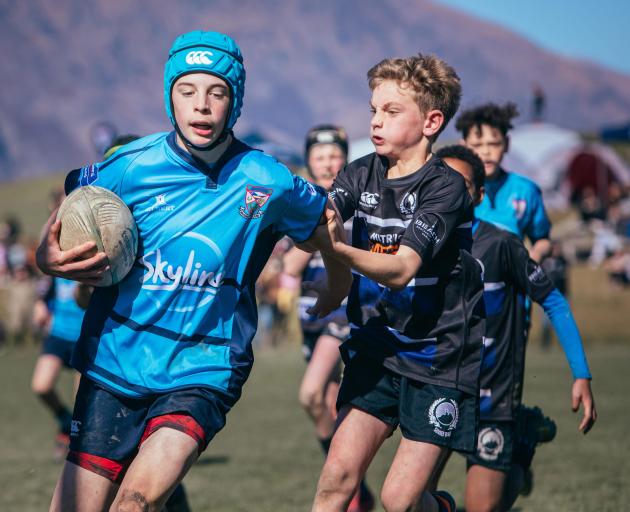 Wakatipu Rugby Club’s Callum Longthorn, 12, puts on a burst of speed to shake off Sumner club...