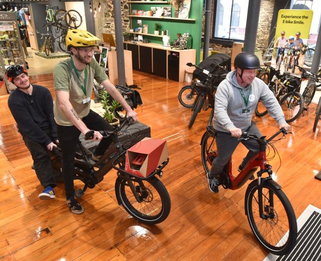 Bike House Sport employees (from left) Angus Reid, Matt Dunstan and Jeff Aldrich take one last...