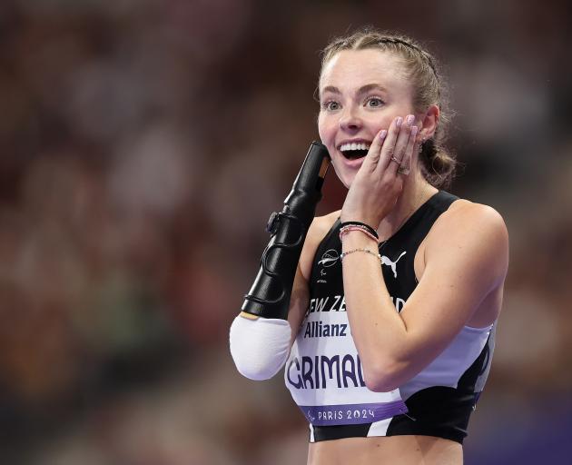 Anna Grimaldi, of Dunedin, celebrates after winning bronze during the Paralympic women’s 100m T47...