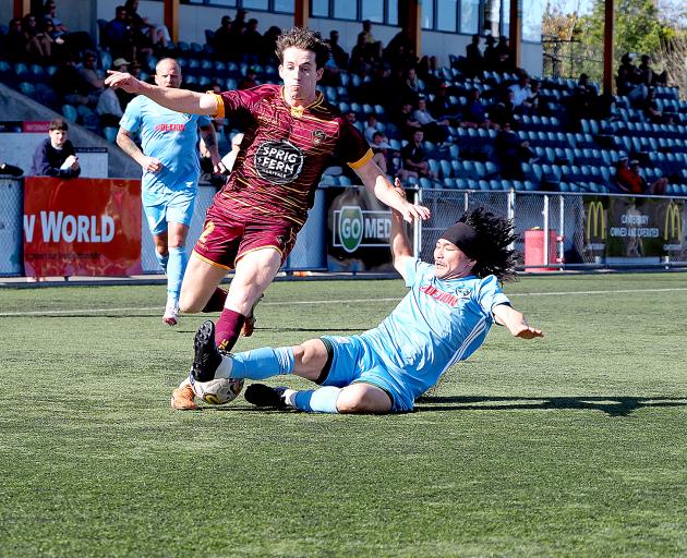 Coastal Spirit’s Sako Satsumi wins the ball off Universities’ Hunter Hine during his side’s 2-1...