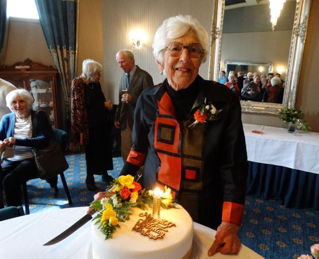 Barbara Simpson prepares to cut her birthday cake adorned in her favourite colours at the Brydone...